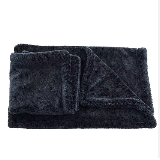 Folded dark gray drying towel on a white background